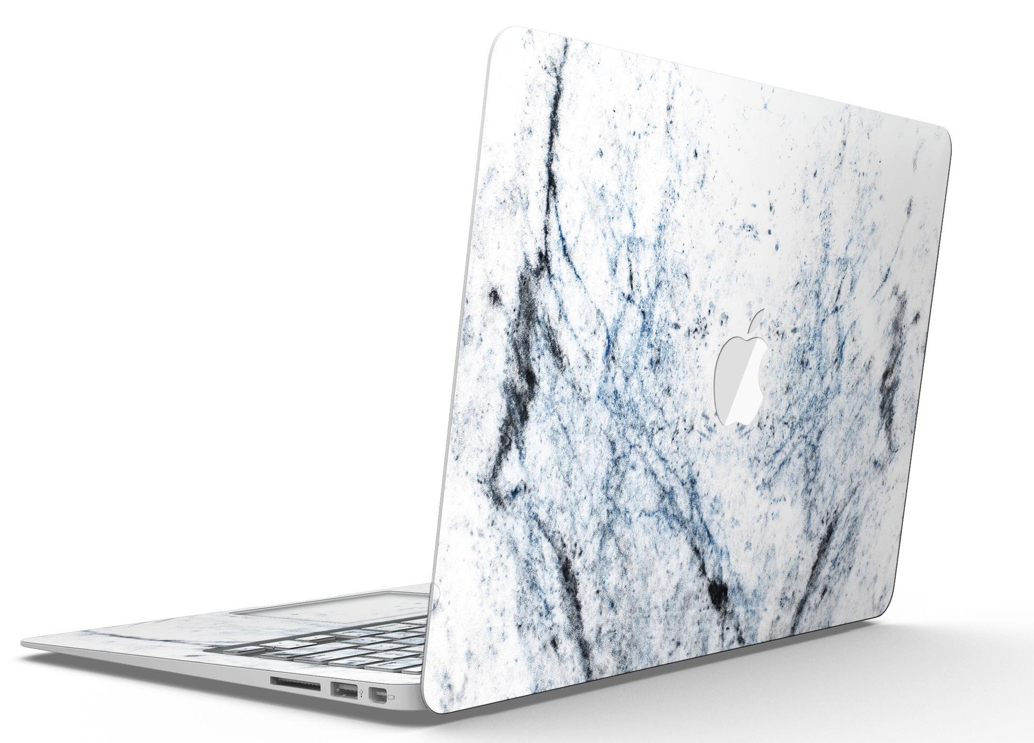 Blue and black grunge skin for MacBook Air on a white marble surface, showcasing stylish design and premium vinyl material.