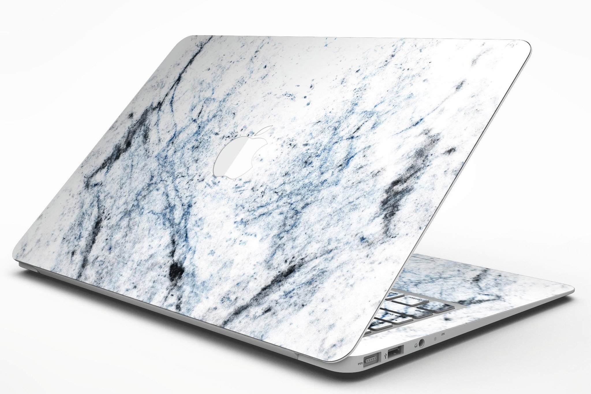 Blue and black grunge skin for MacBook Air on a white marble surface, showcasing stylish design and premium vinyl material.