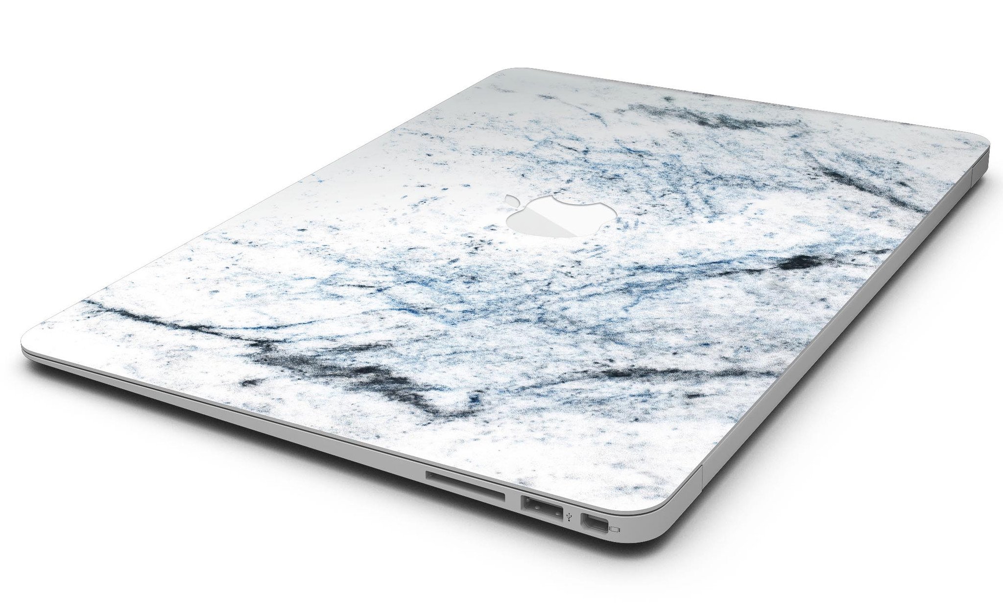 Blue and black grunge skin for MacBook Air on a white marble surface, showcasing stylish design and premium vinyl material.