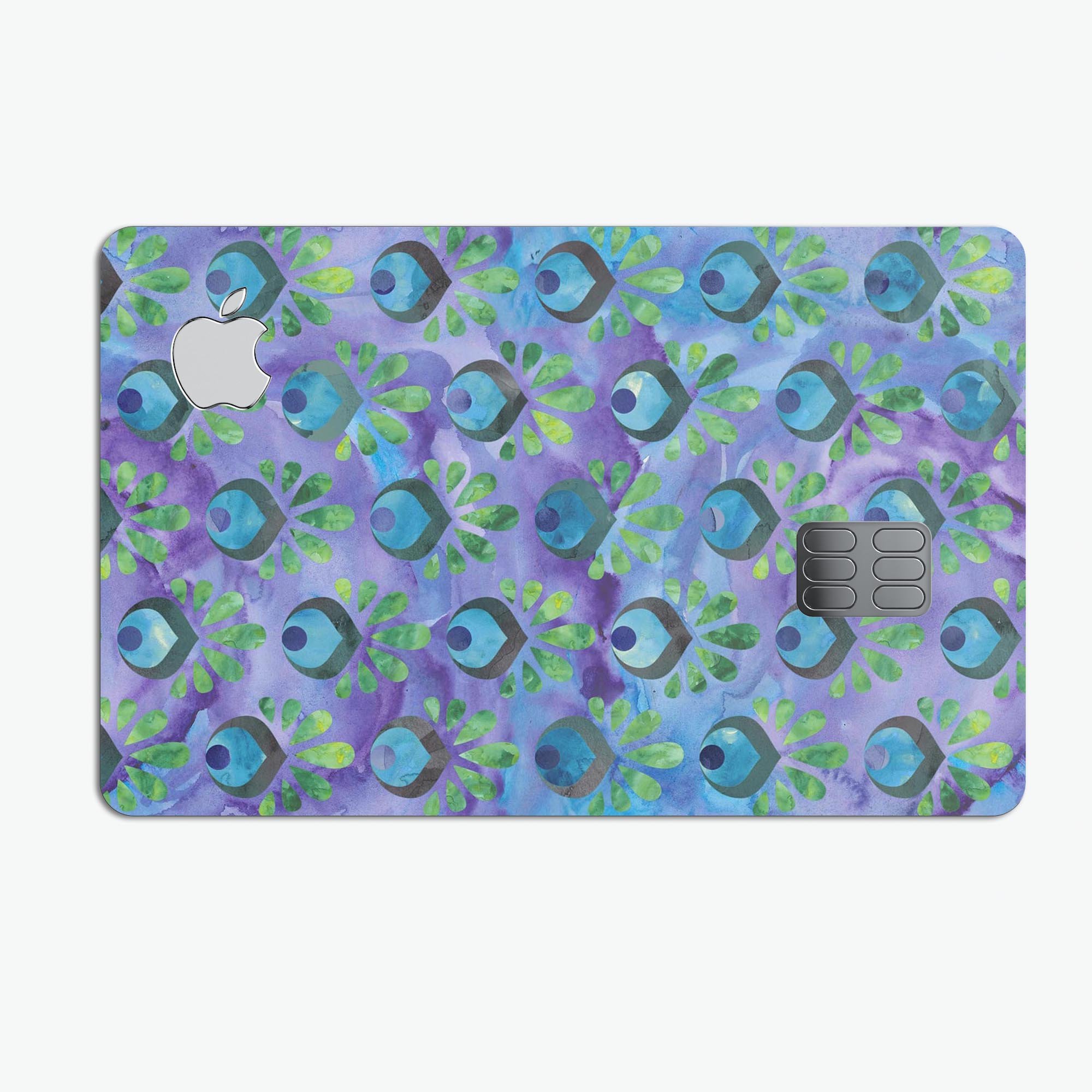 Blue and purple watercolor peacock feathers design on a premium protective decal for Apple Card.