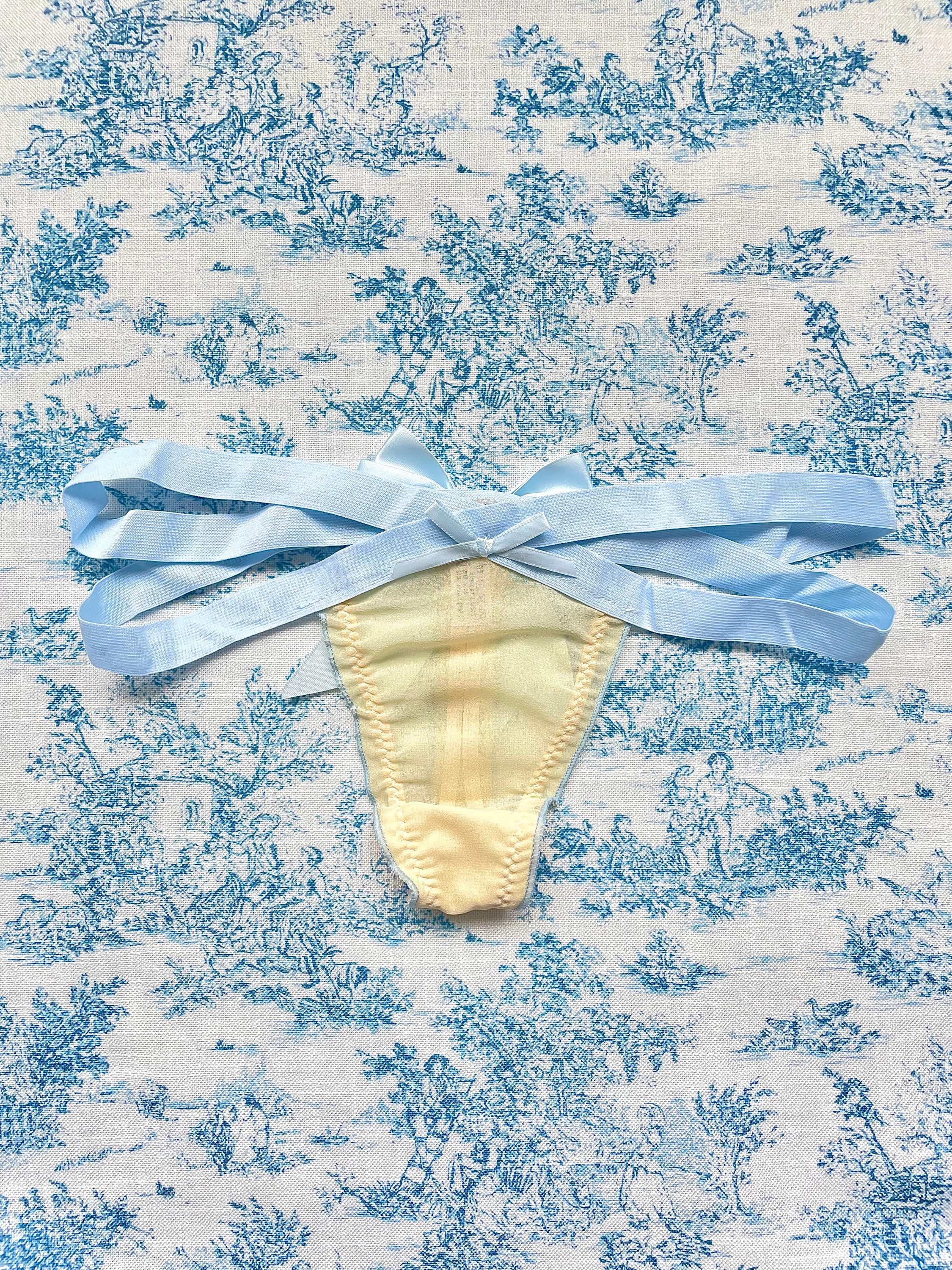 Blue Strap Bow Panty featuring tan mesh and blue satin bow, showcasing elegant design and comfort.