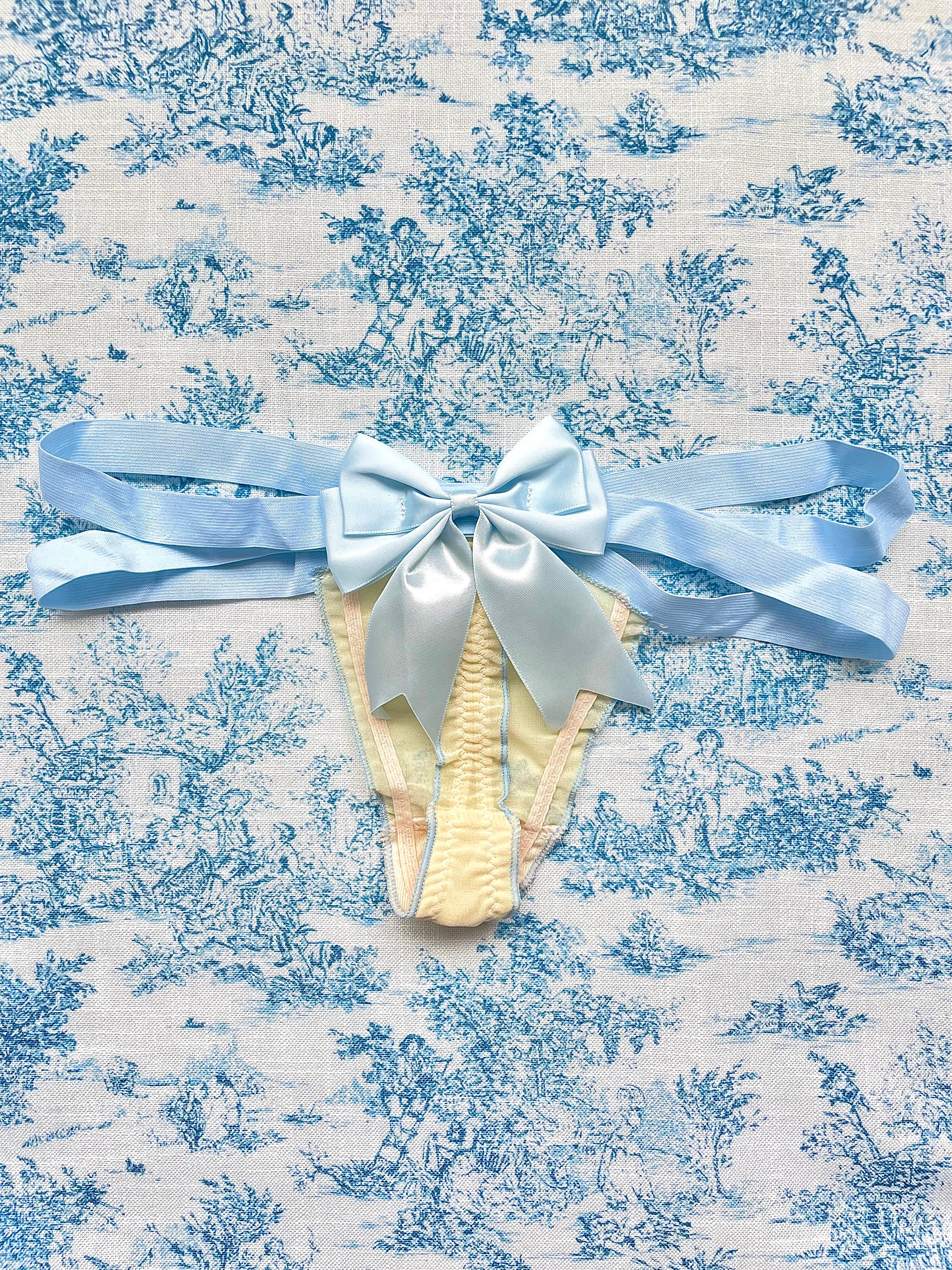 Blue Strap Bow Panty featuring tan mesh and blue satin bow, showcasing elegant design and comfort.