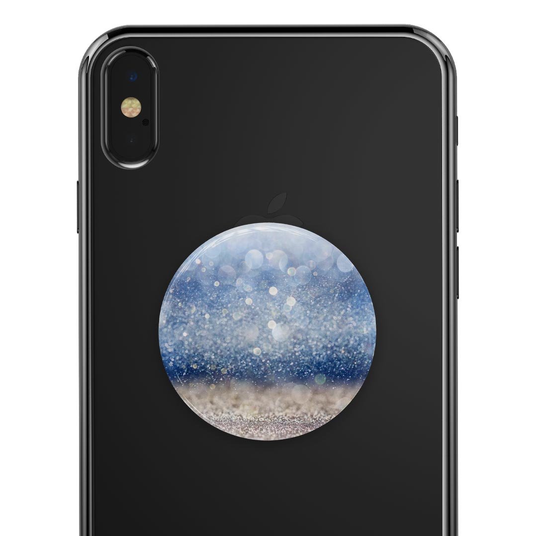 Blue Unfocused Silver Sparkle Skin Kit for PopSockets, showcasing a vibrant blue and silver sparkle design on a smartphone grip.