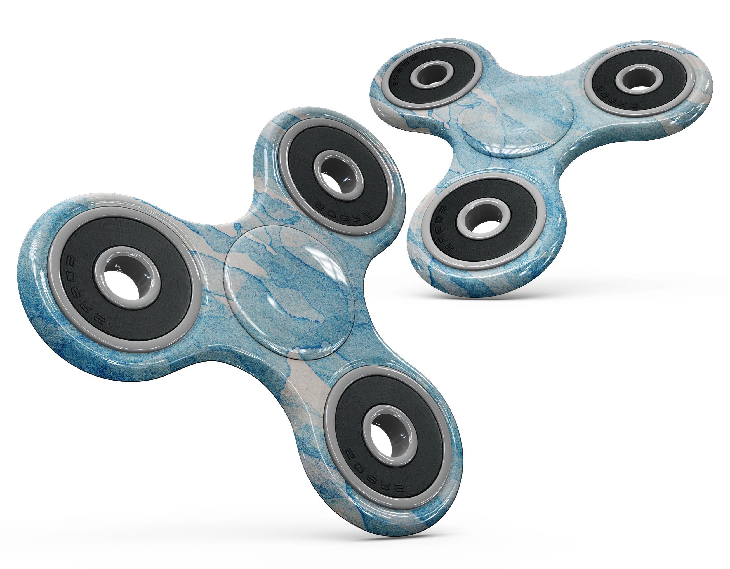 Blue Watercolor Drizzle Fidget Spinner Skin-Kit showcasing vibrant colors and premium vinyl material.