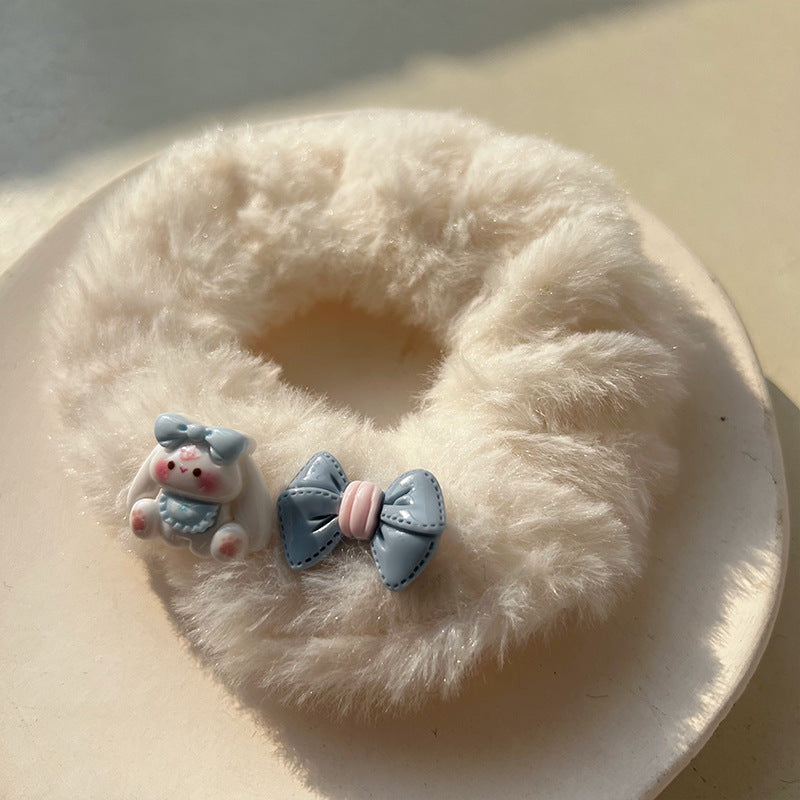 Blue and white plush hair tie featuring a cute big-eared dog design, perfect for adding charm to hairstyles.