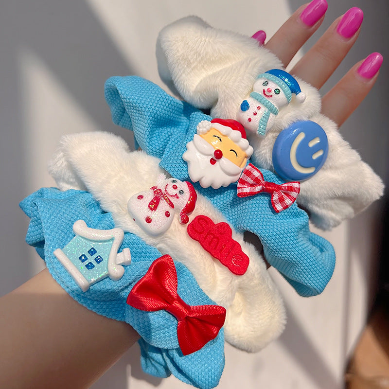 Blue and white hair tie featuring a cute snowman bow design, perfect for winter hairstyles.