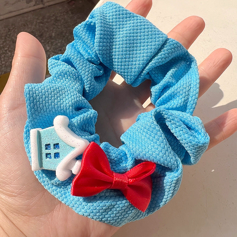 Blue and white hair tie featuring a cute snowman bow design, perfect for winter hairstyles.