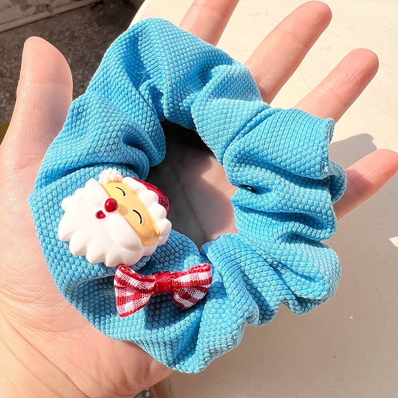 Blue and white hair tie featuring a cute snowman bow design, perfect for winter hairstyles.