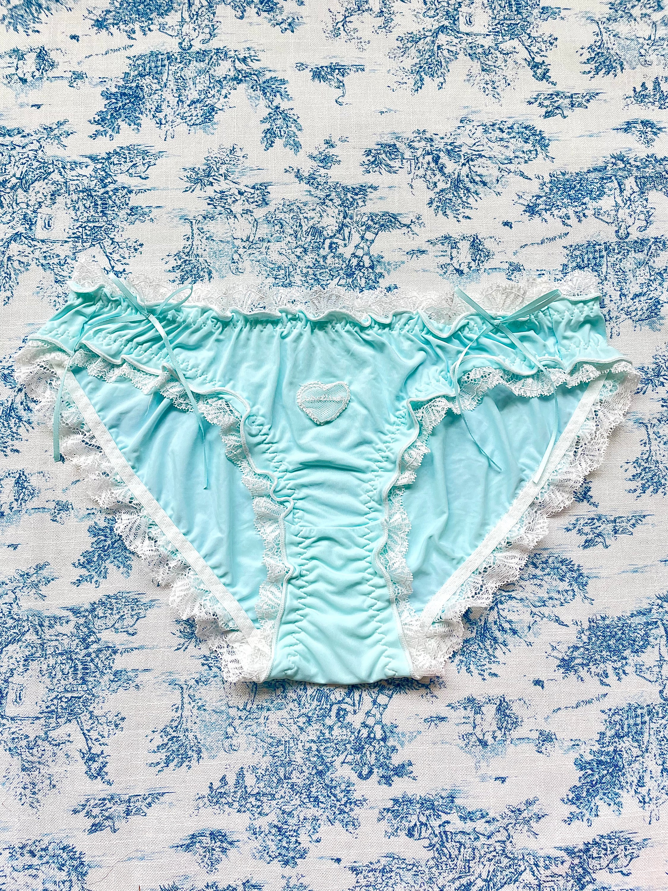 Blue and white lace trim panty featuring a heart design and bow details, crafted from 100% cotton lining.