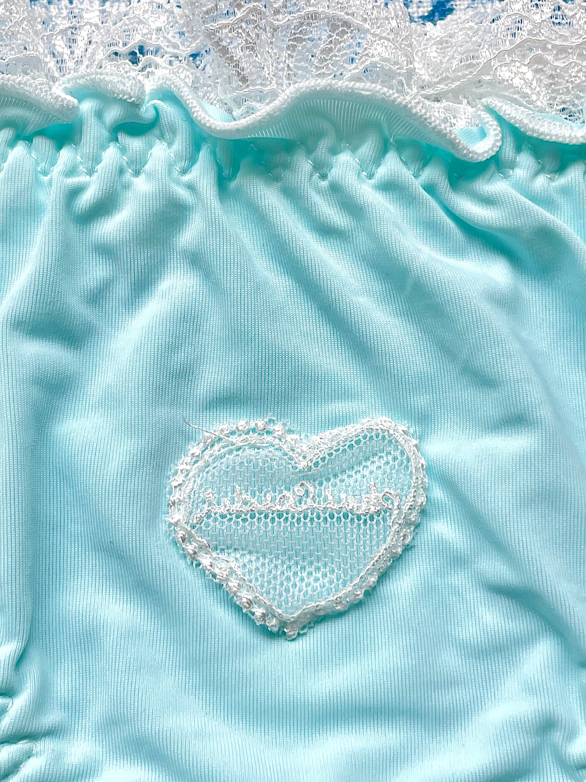 Blue and white lace trim panty featuring a heart design and bow details, crafted from 100% cotton lining.