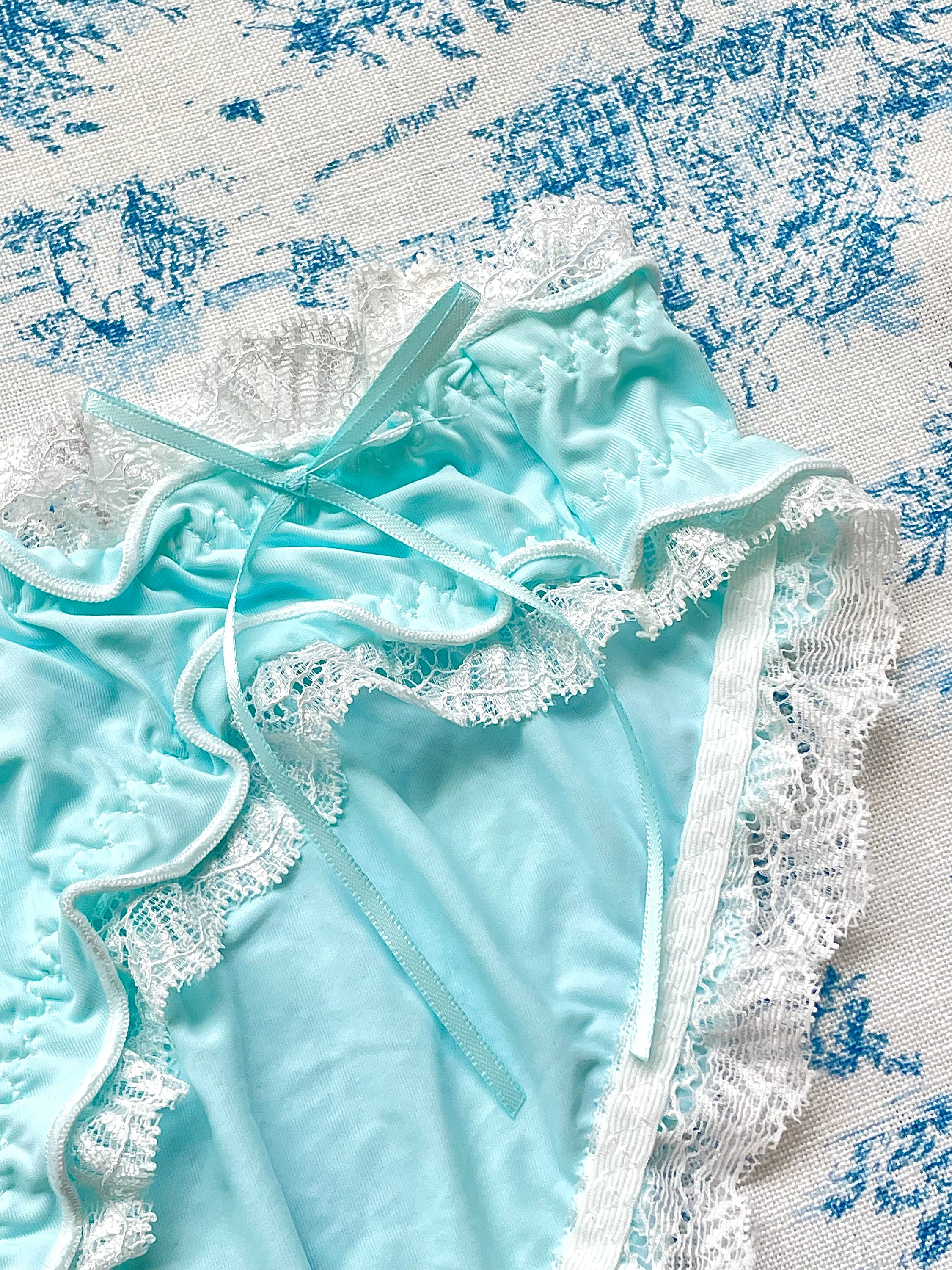 Blue and white lace trim panty featuring a heart design and bow details, crafted from 100% cotton lining.