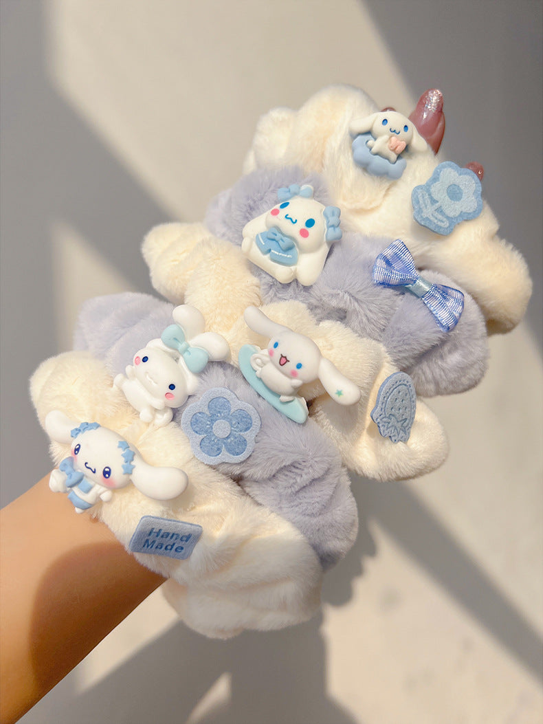 A set of five blue and white plush hair ties, showcasing different stylish designs for versatile hairstyles.