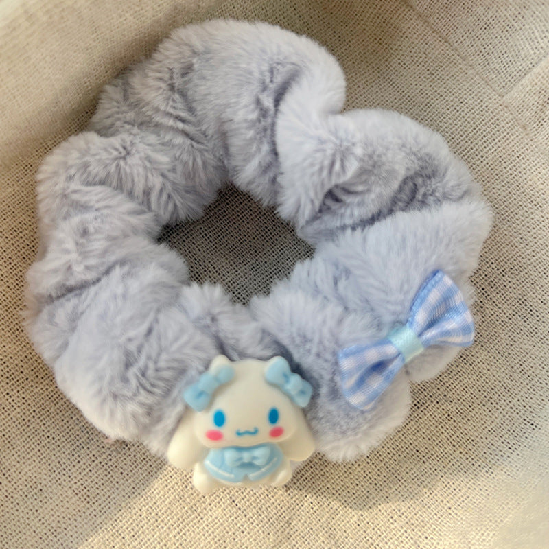 A set of five blue and white plush hair ties, showcasing different stylish designs for versatile hairstyles.