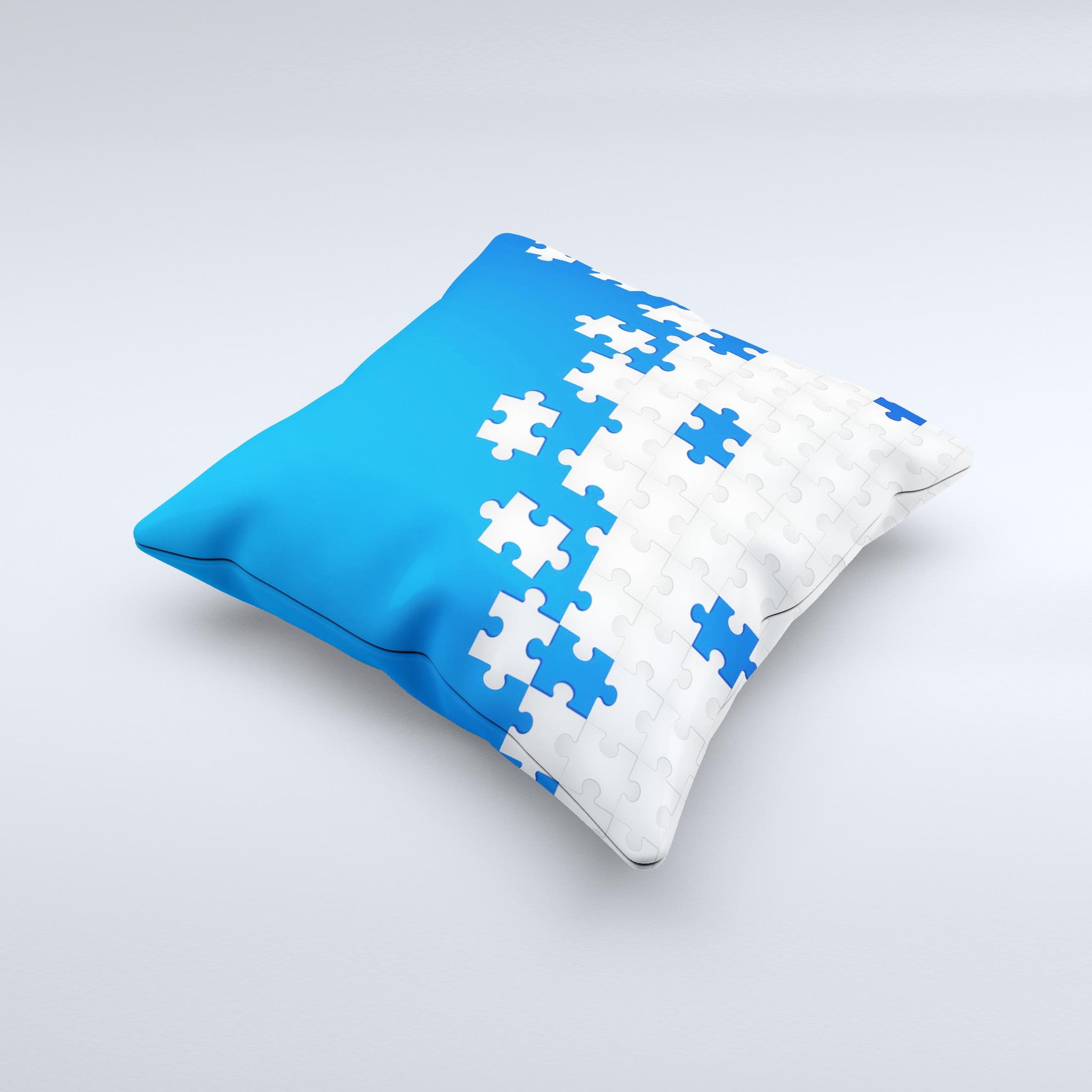 Blue and white decorative throw pillow with scattered puzzle design, handcrafted in Virginia, showcasing unique ink-fuzed graphics.