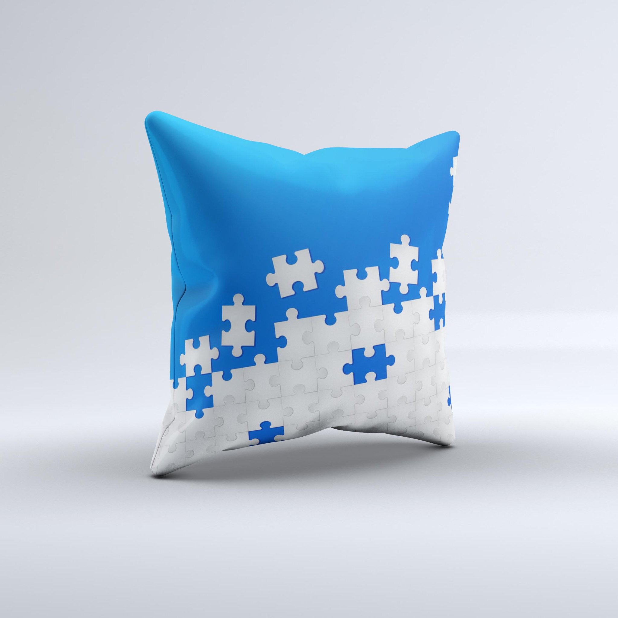 Blue and white decorative throw pillow with scattered puzzle design, handcrafted in Virginia, showcasing unique ink-fuzed graphics.