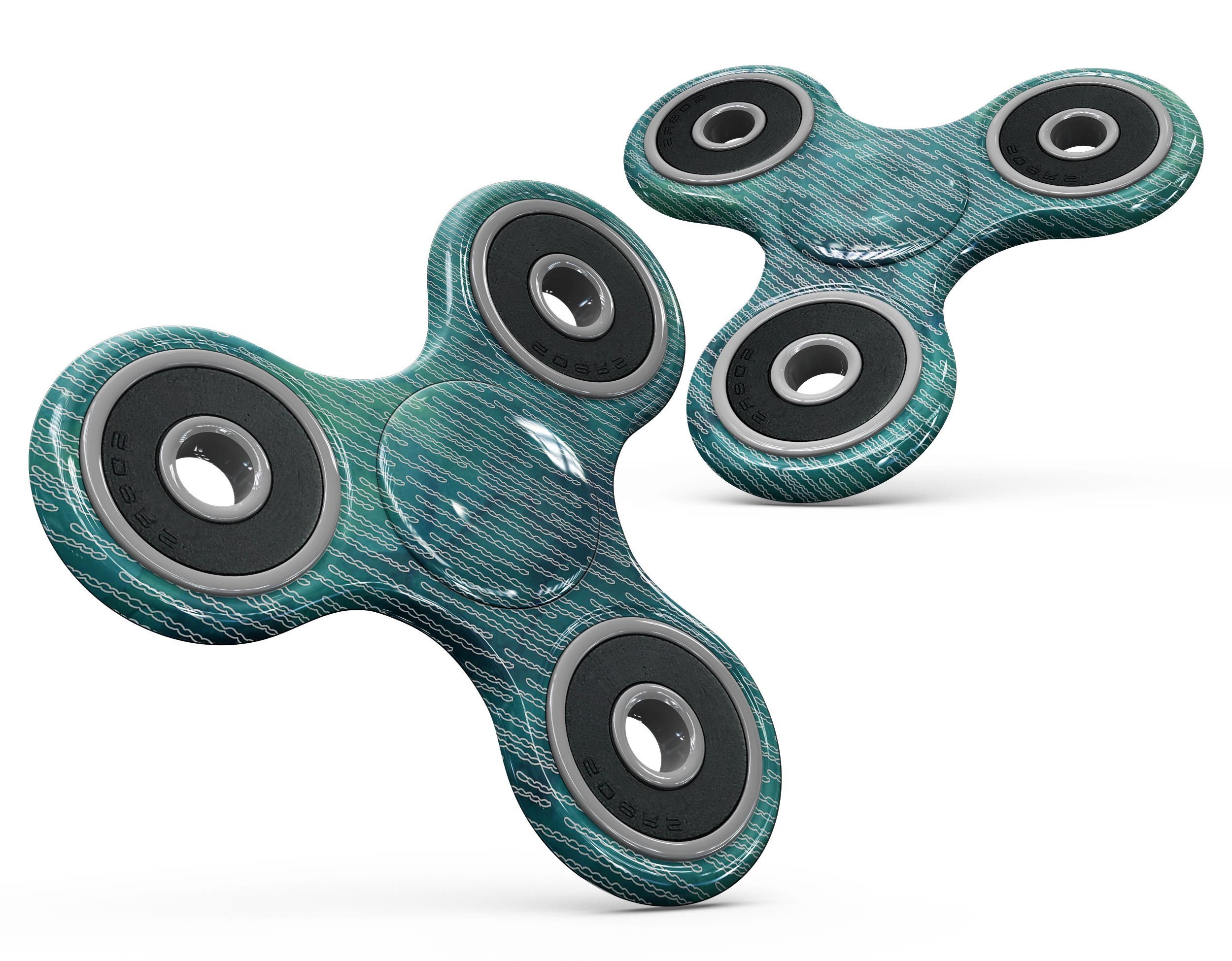 Blue-green watercolor squiggles design on a fidget spinner skin kit, showcasing vibrant colors and unique patterns.