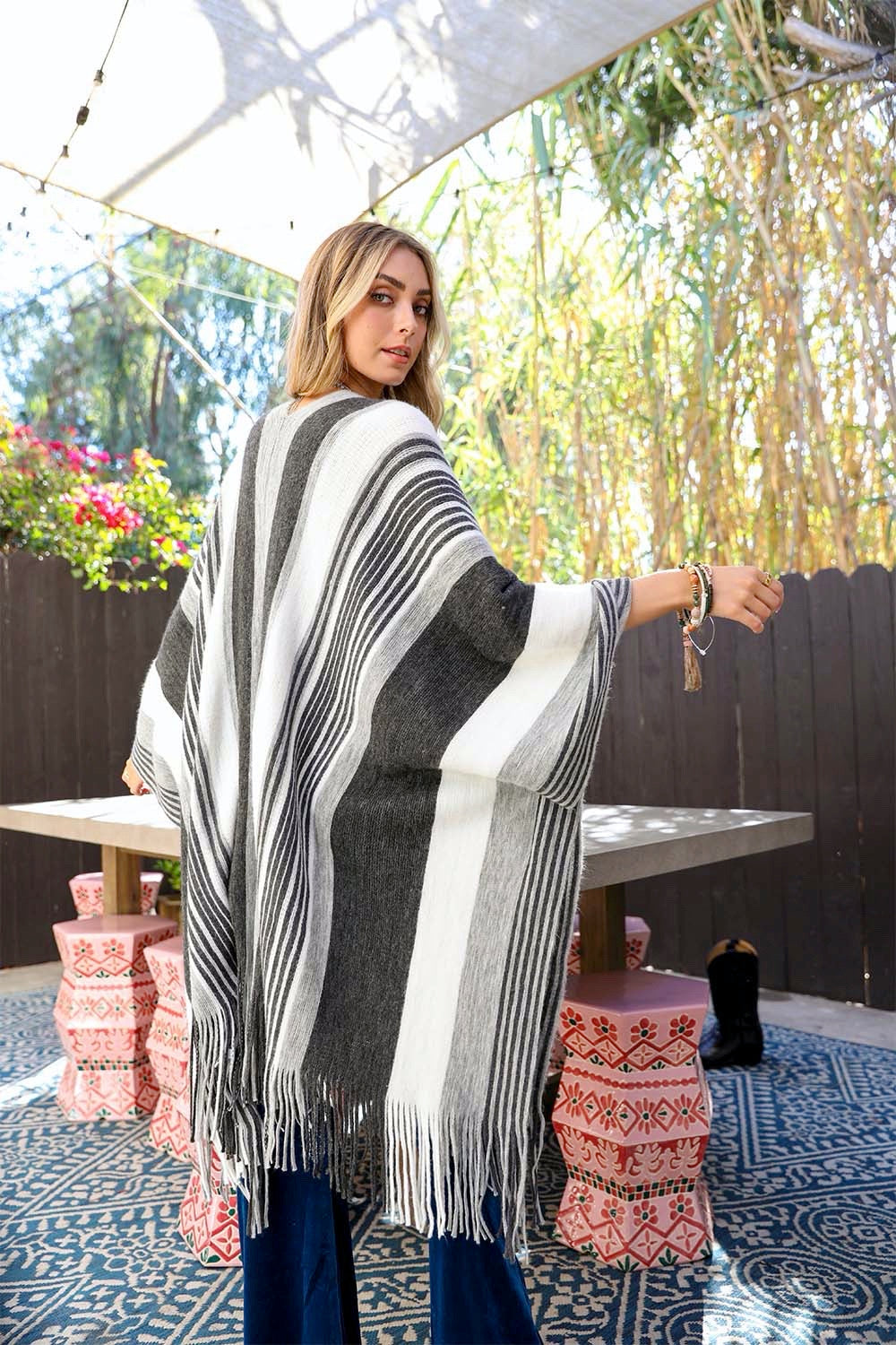 A stylish Boho Chic Frayed Edge Ruana featuring a striped pattern and frayed edges, perfect for layering.