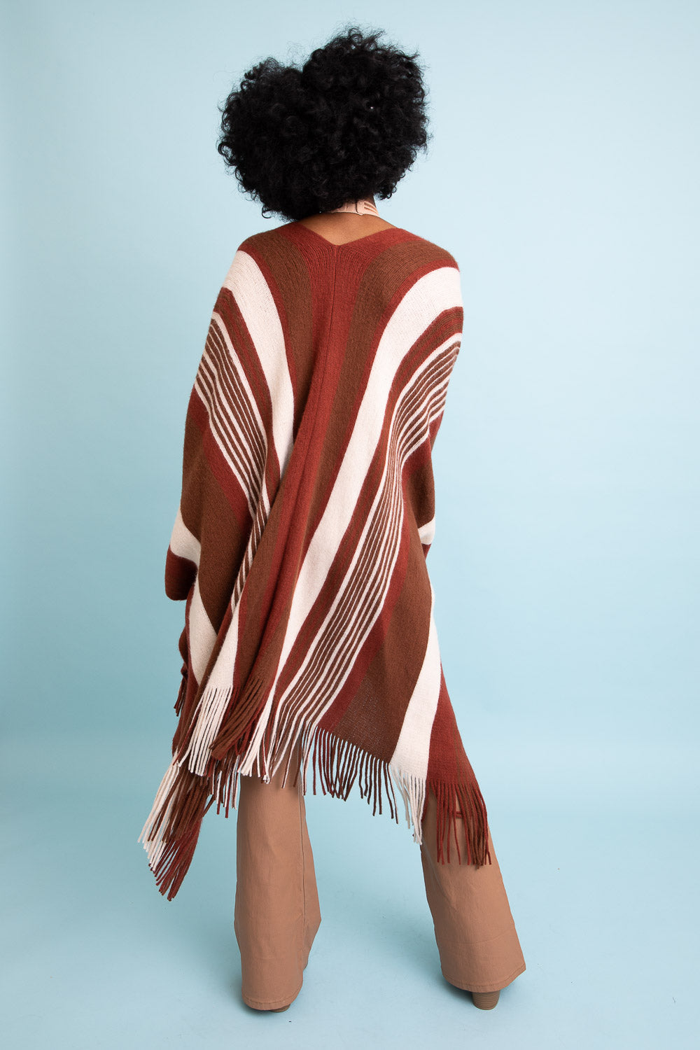 A stylish Boho Chic Frayed Edge Ruana featuring a striped pattern and frayed edges, perfect for layering.