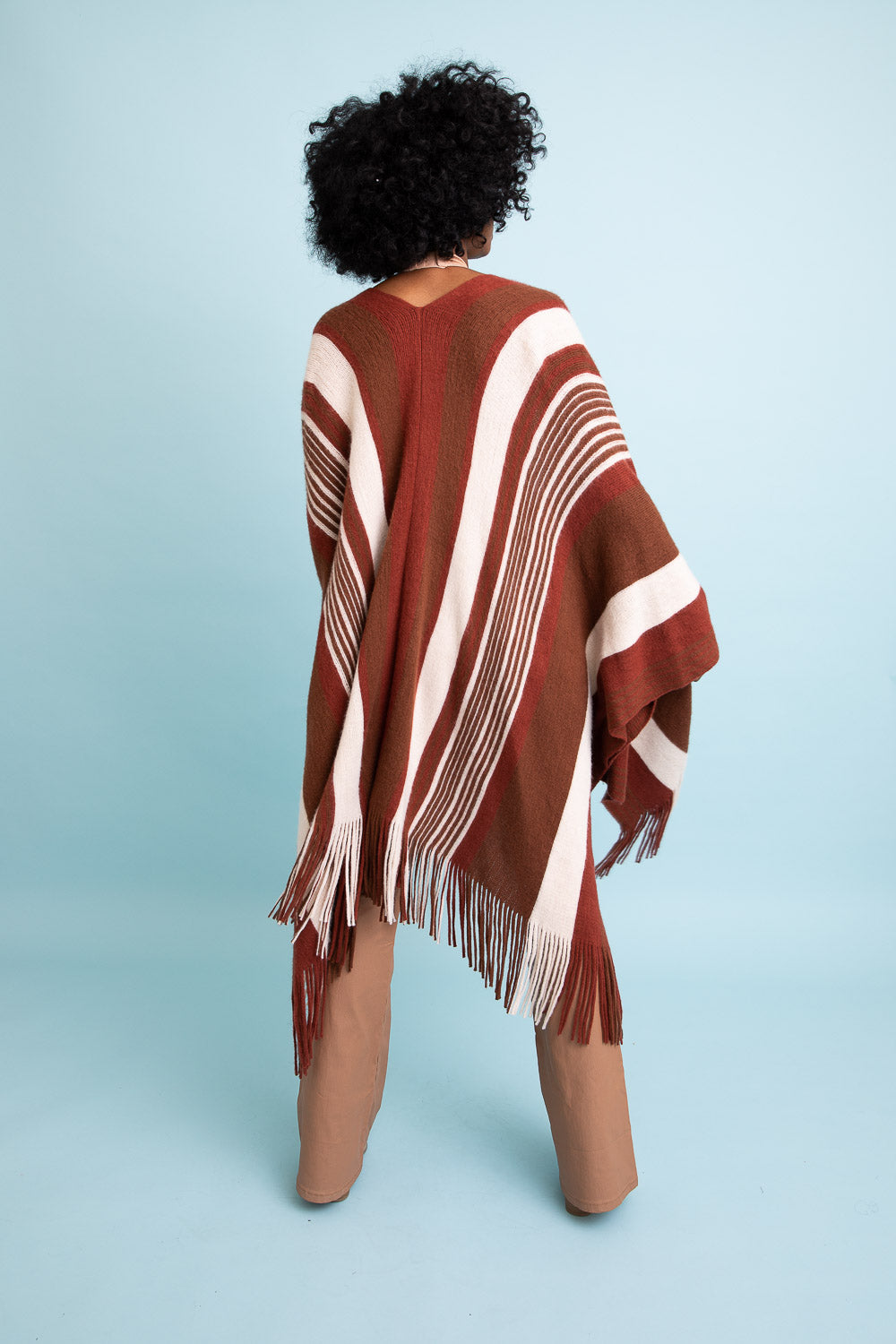 A stylish Boho Chic Frayed Edge Ruana featuring a striped pattern and frayed edges, perfect for layering.