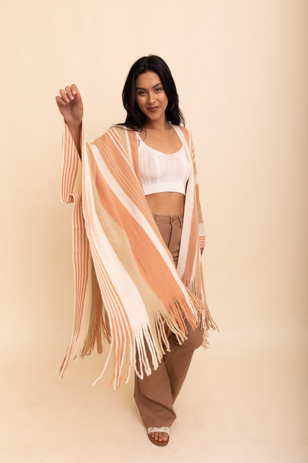 A stylish Boho Chic Frayed Edge Ruana featuring a striped pattern and frayed edges, perfect for layering.