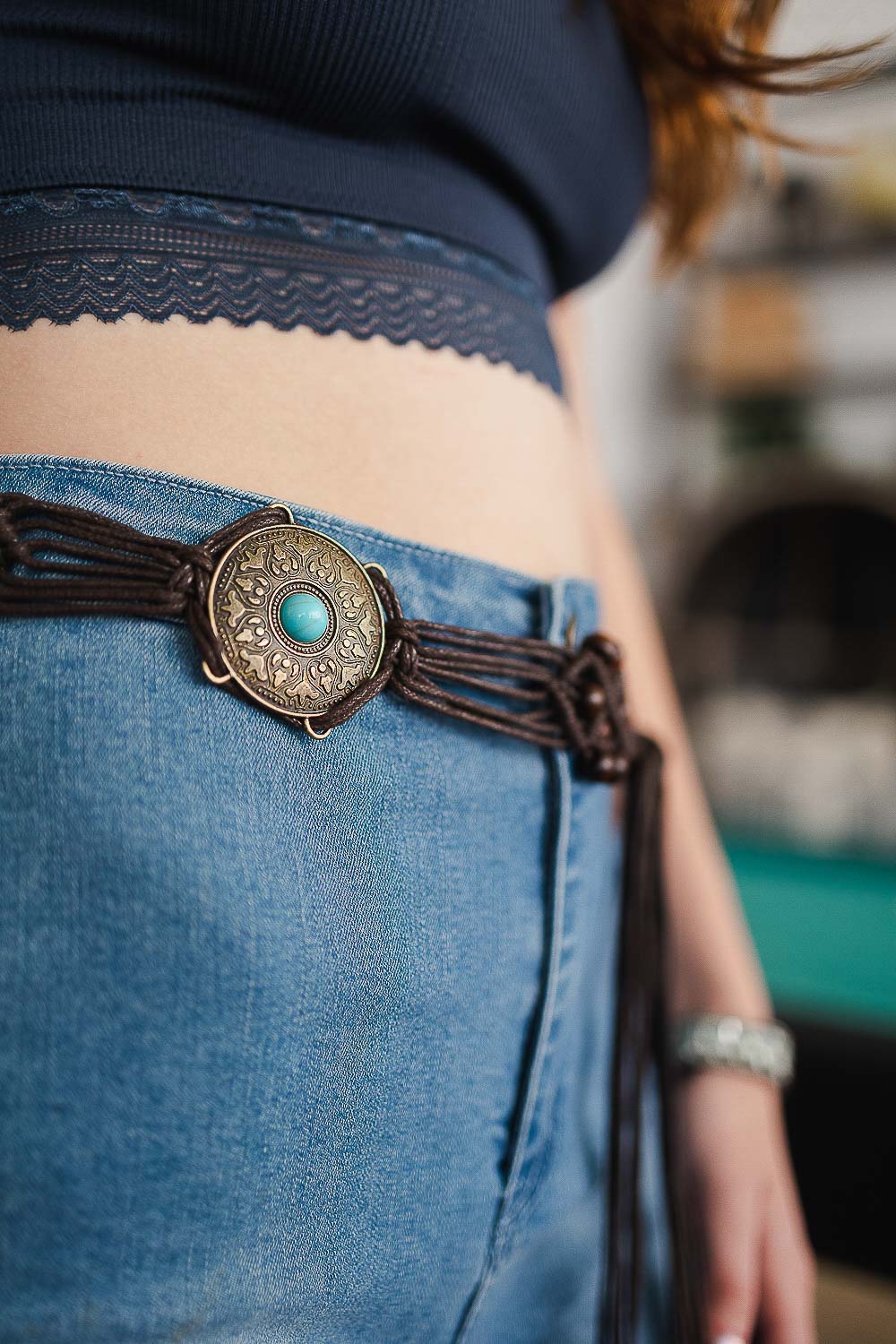 A stylish Boho Medallion Macrame Belt featuring intricate knotting and a playful medallion detail, perfect for summer outfits.