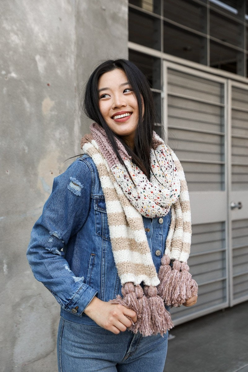 Boho Speckle Stripe Tassel Scarf featuring a unique speckle pattern and playful tassels, showcasing its cozy and stylish design.