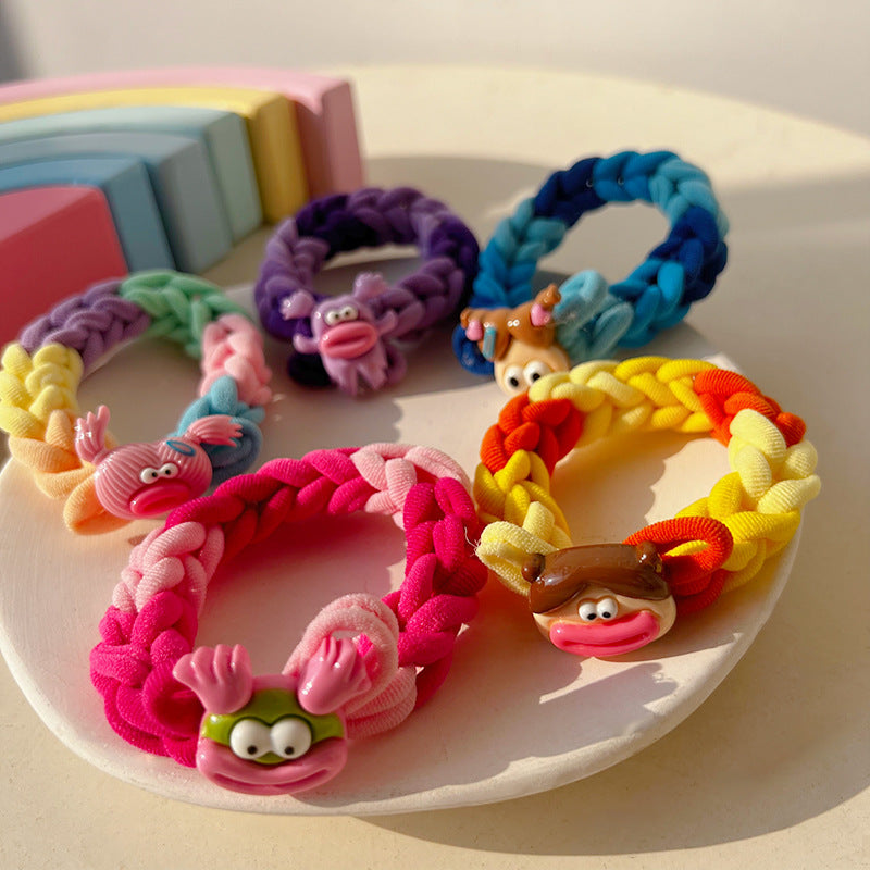 A colorful braided hair tie designed for playful hairstyles, featuring a whimsical doll-inspired design.