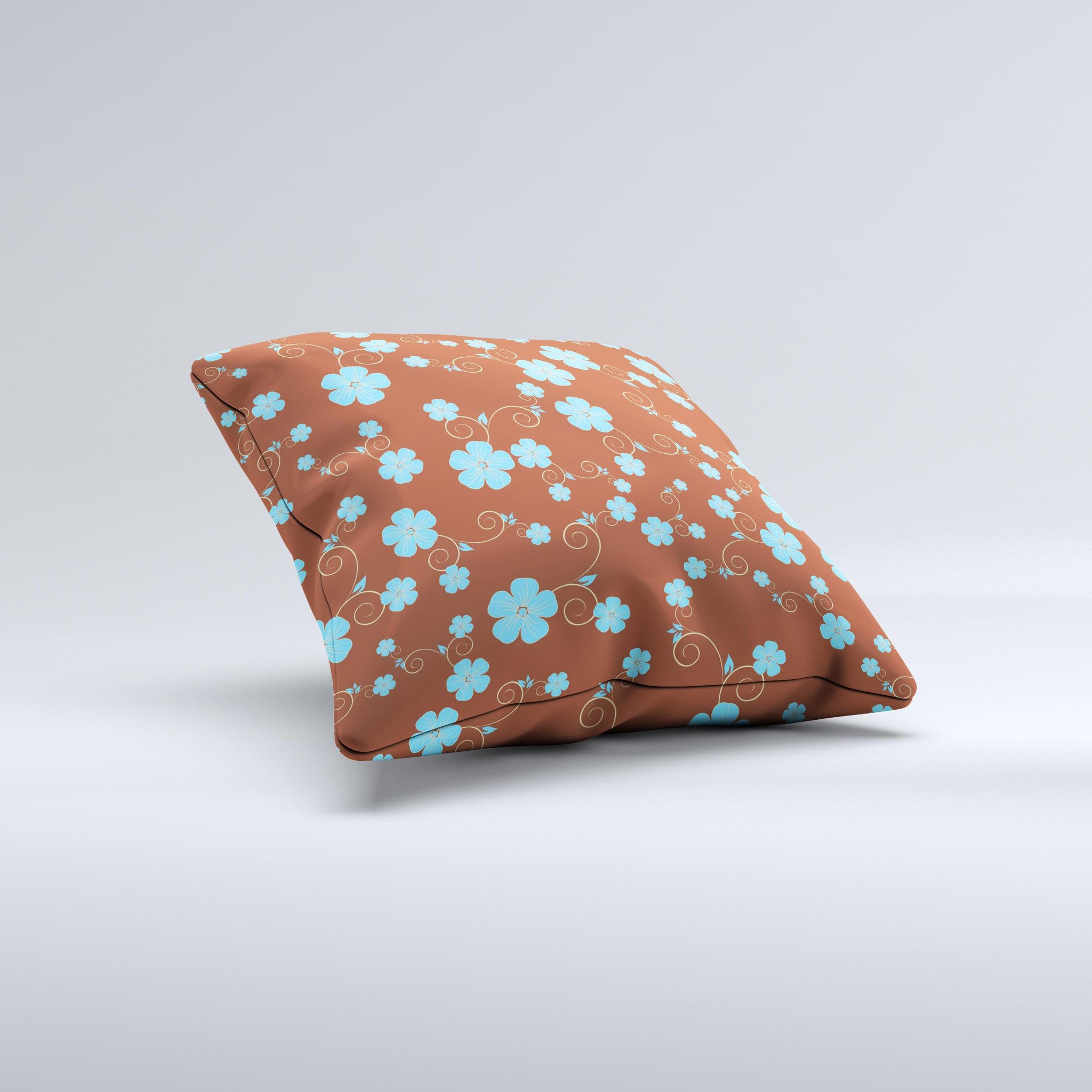 Brown and blue floral decorative throw pillow with intricate ink-fuzed design, showcasing a handcrafted appearance.