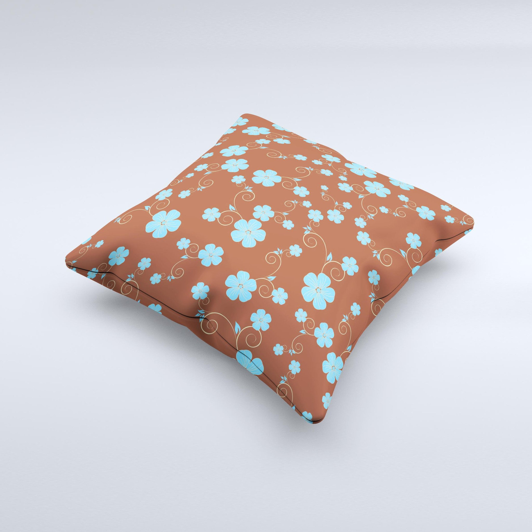 Brown and blue floral decorative throw pillow with intricate ink-fuzed design, showcasing a handcrafted appearance.