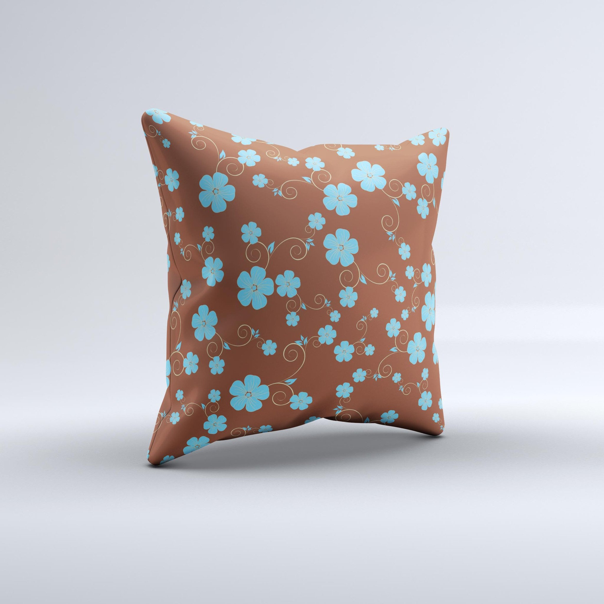 Brown and blue floral decorative throw pillow with intricate ink-fuzed design, showcasing a handcrafted appearance.