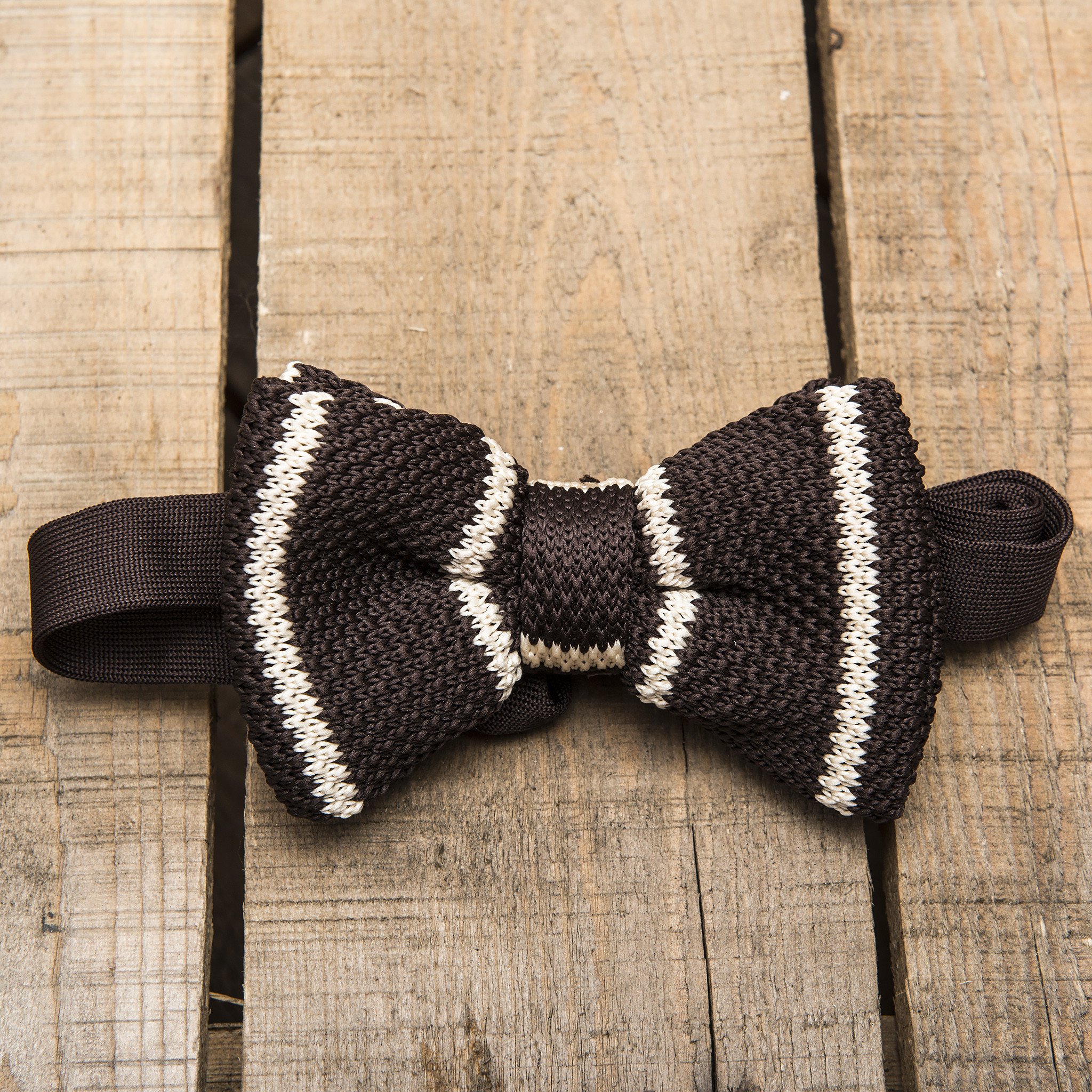 A stylish brown and cream striped bow tie, elegantly crafted with a knitted texture, perfect for formal occasions.