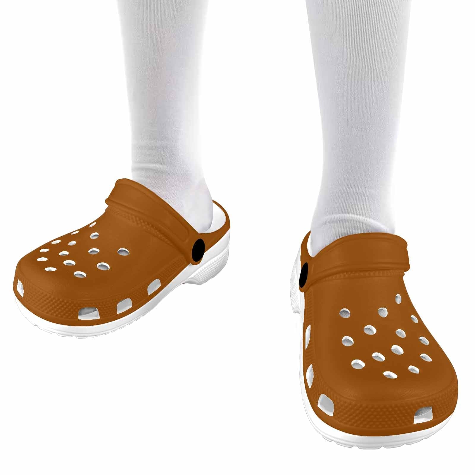 A pair of stylish brown clogs designed for youth, featuring a slip-on design, ventilation ports, and cushioned soles for comfort.