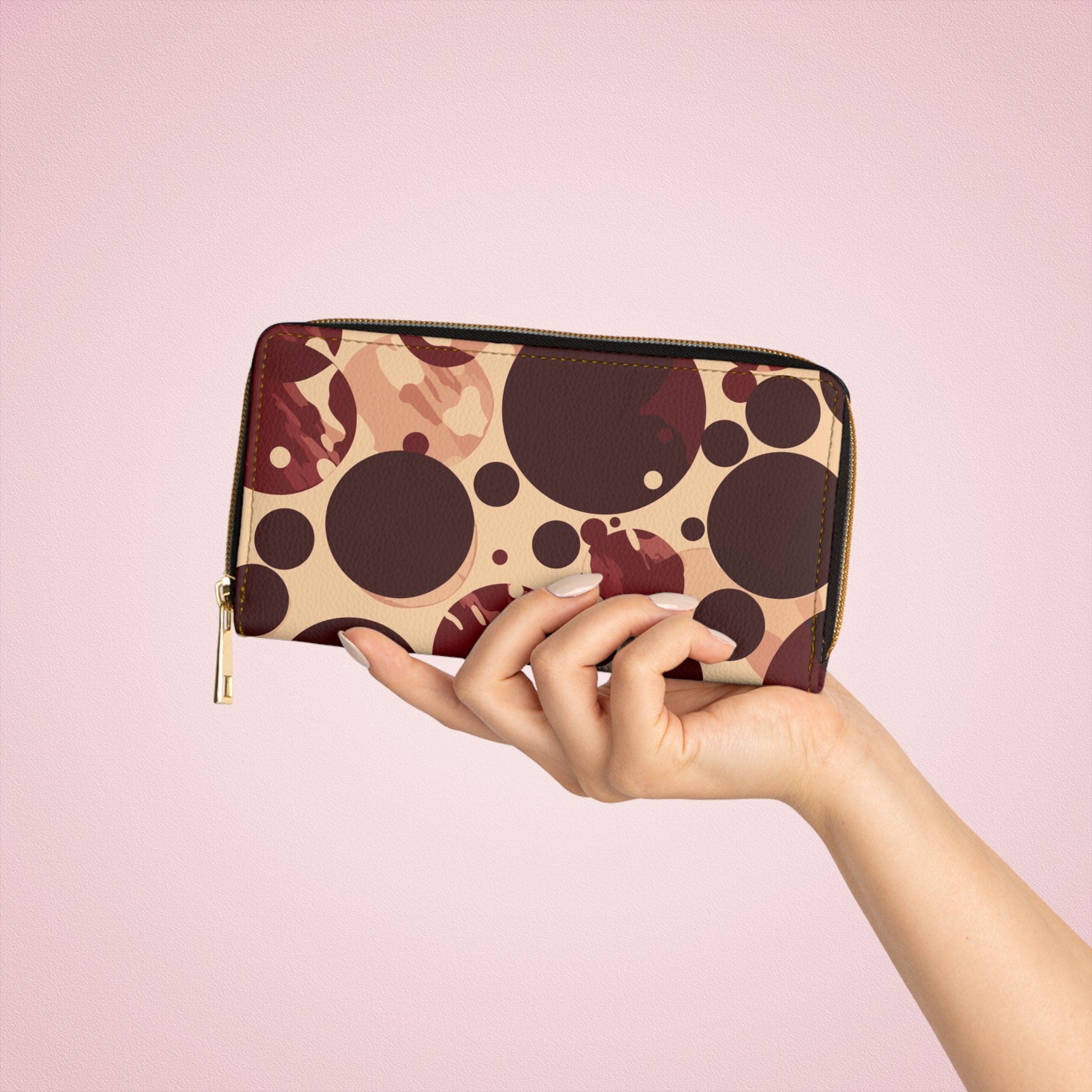 Burgundy and beige women's zipper wallet with circular spotted illustration, showcasing its stylish design and functional compartments.