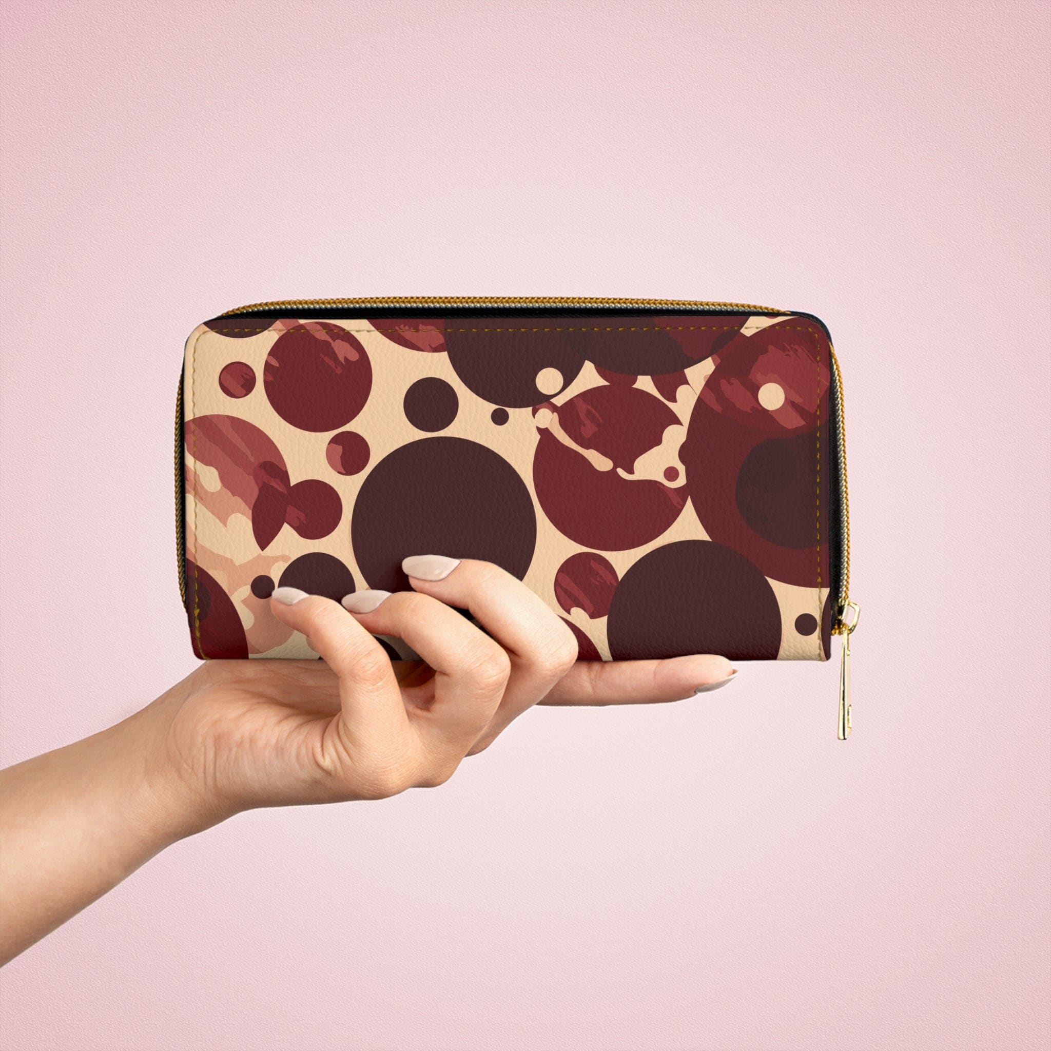 Burgundy and beige women's zipper wallet with circular spotted illustration, showcasing its stylish design and functional compartments.