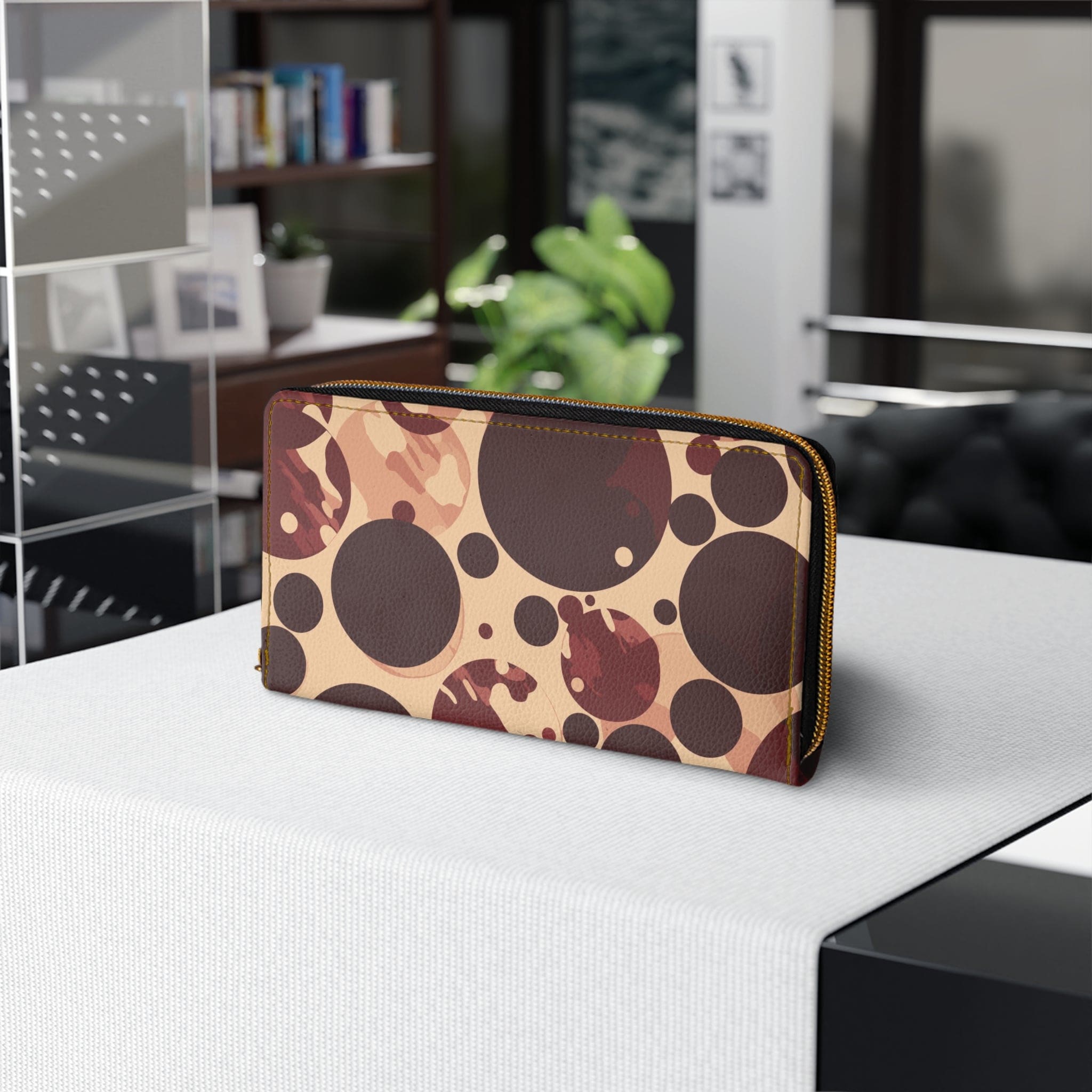 Burgundy and beige women's zipper wallet with circular spotted illustration, showcasing its stylish design and functional compartments.