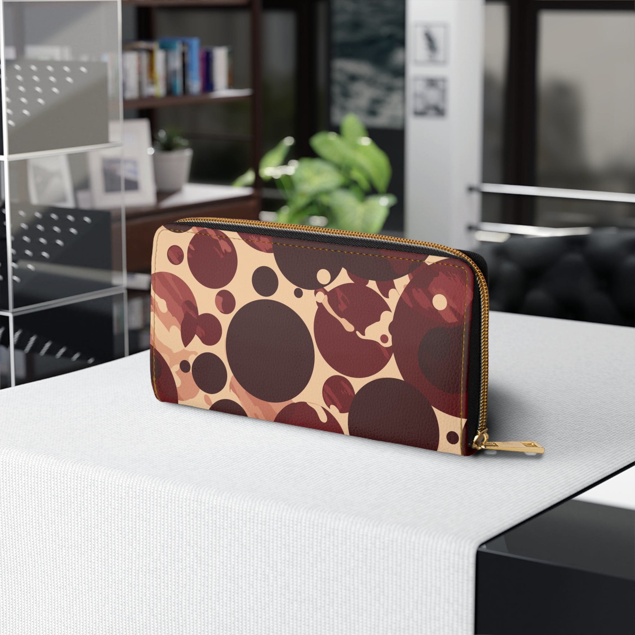 Burgundy and beige women's zipper wallet with circular spotted illustration, showcasing its stylish design and functional compartments.