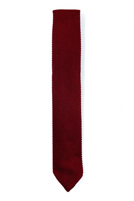 A stylish burgundy knitted tie with a pointed end, made from durable polyester, perfect for formal occasions.