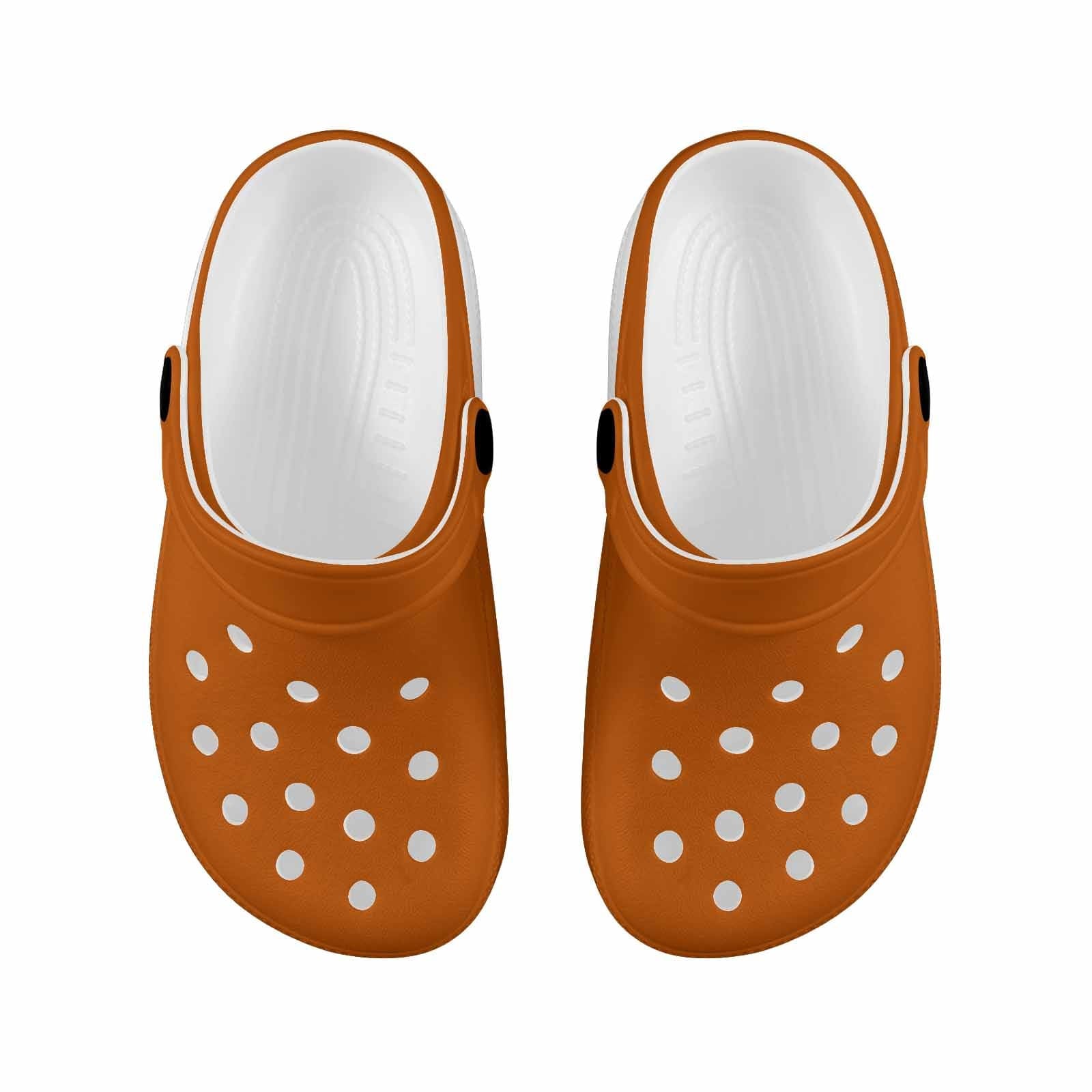 A pair of burnt orange clogs designed for youth, featuring a slip-on design, ventilation ports, and cushioned soles for comfort.