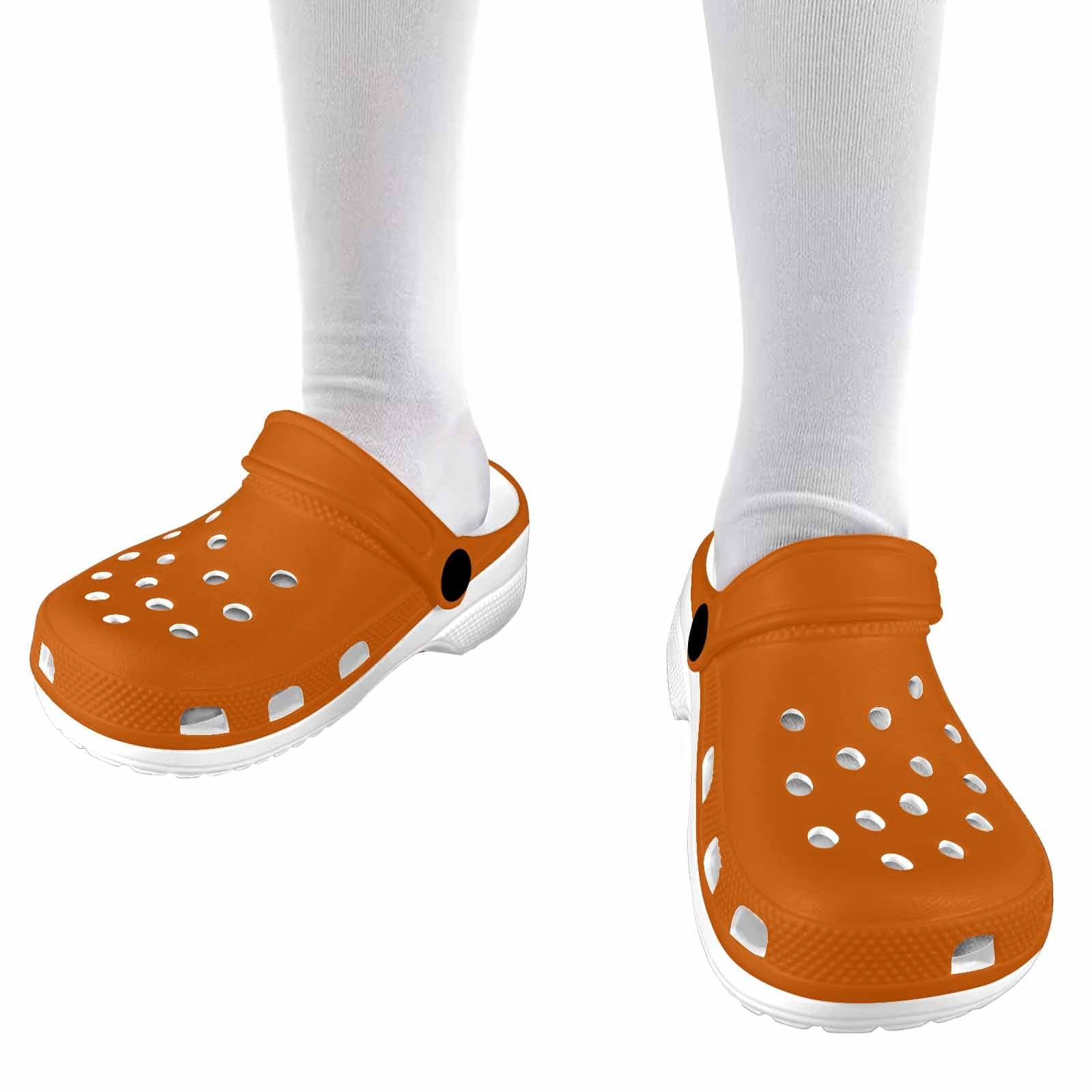 A pair of burnt orange clogs designed for youth, featuring a slip-on design, ventilation ports, and cushioned soles for comfort.