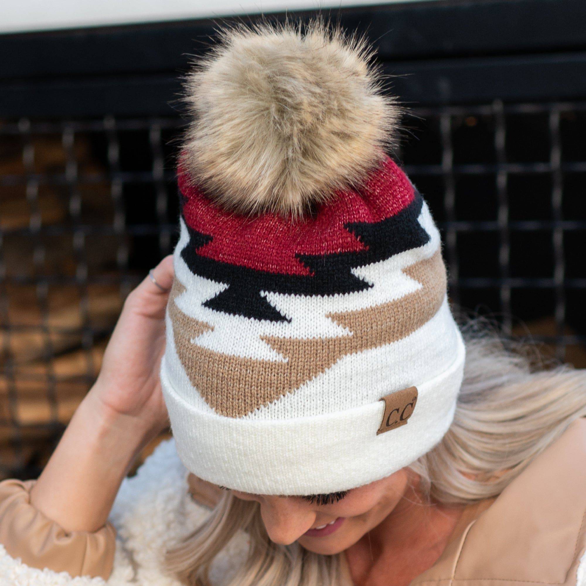 CC Beanie with Pom featuring a South Western Aztec pattern, showcasing its soft faux fur pom pom and vibrant design.