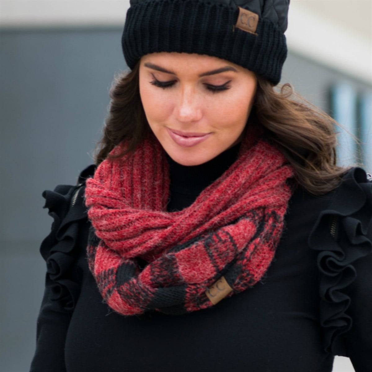 A cozy CC Buffalo Plaid Scarf featuring a classic black and red buffalo plaid pattern, perfect for stylish warmth on cold days.