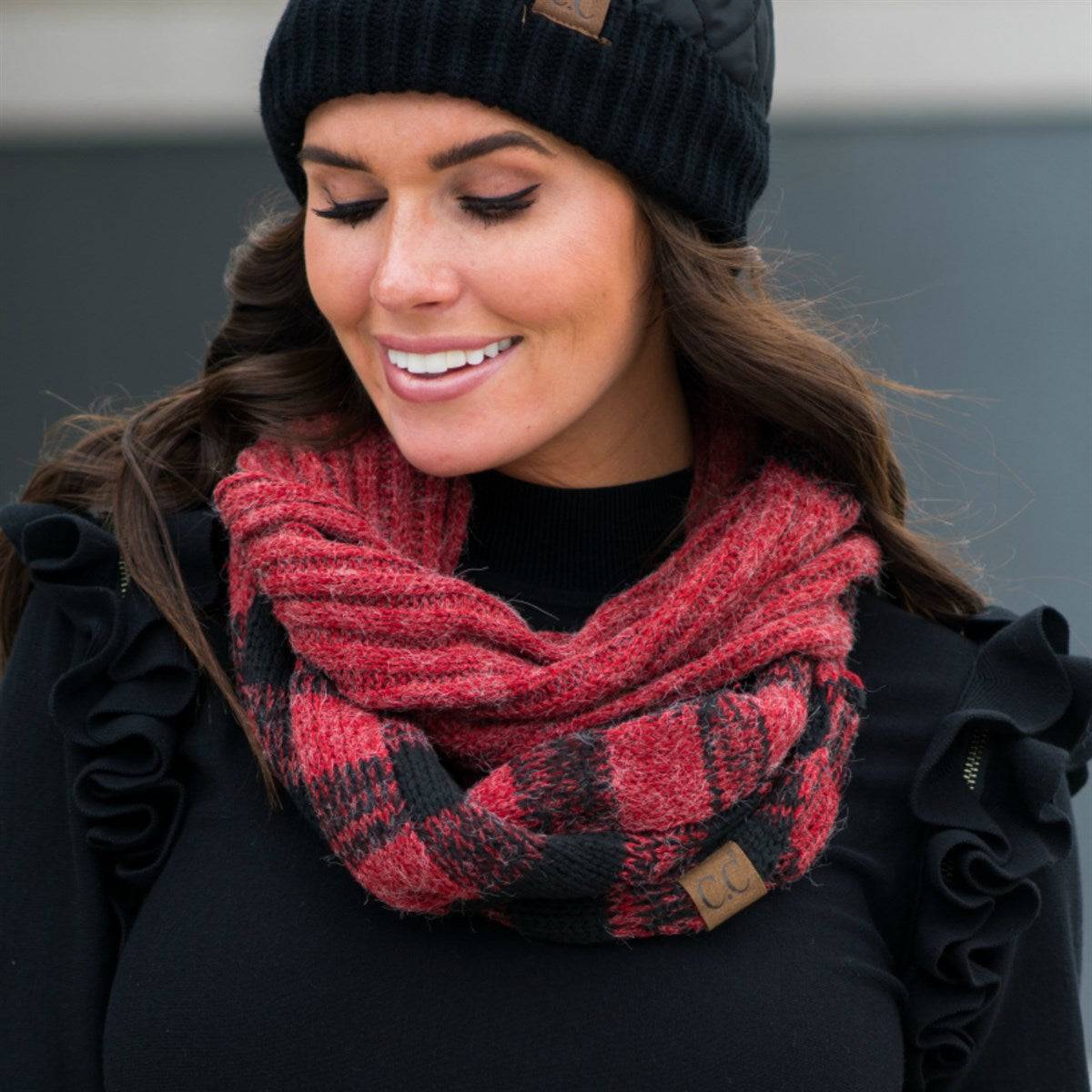 A cozy CC Buffalo Plaid Scarf featuring a classic black and red buffalo plaid pattern, perfect for stylish warmth on cold days.