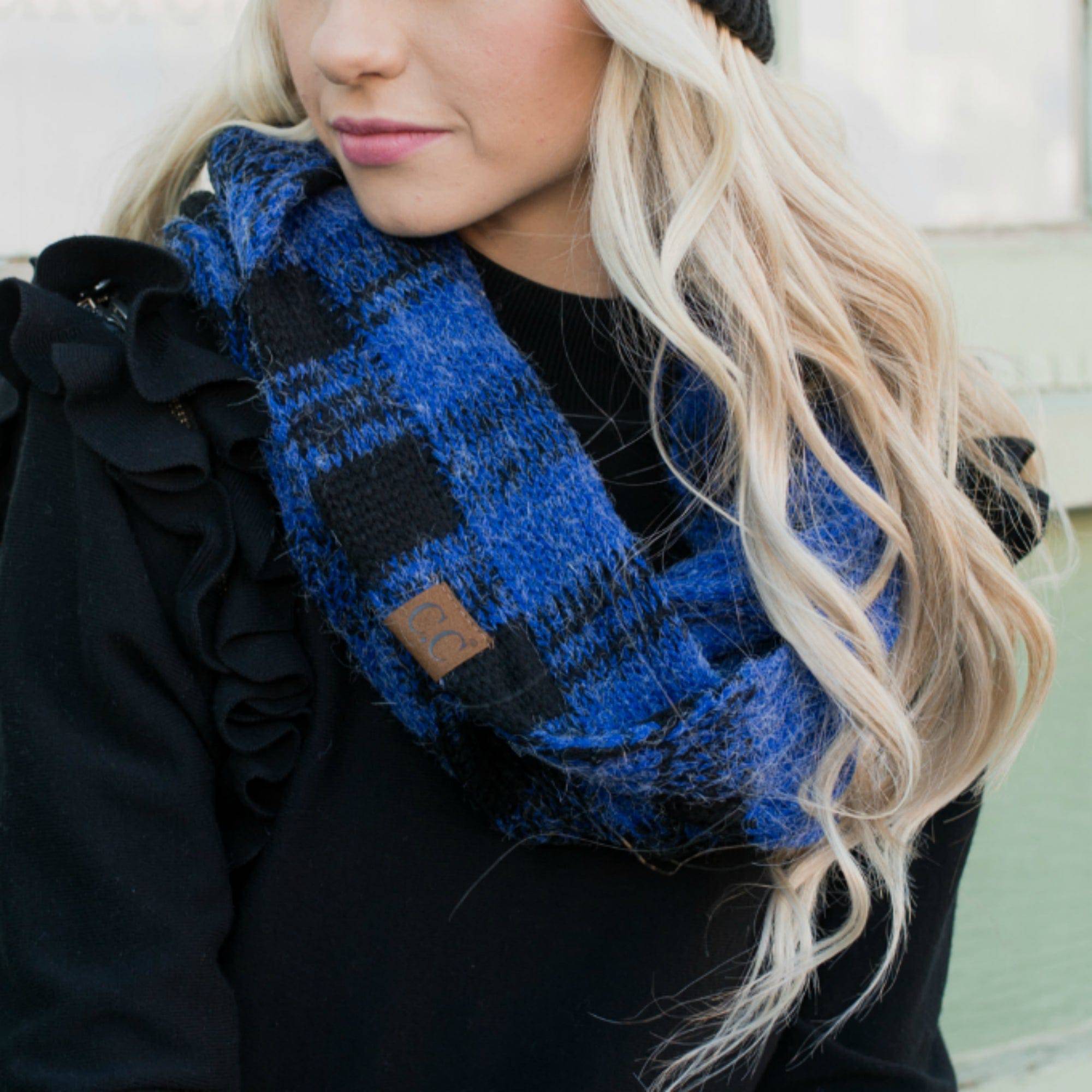 A cozy CC Buffalo Plaid Scarf featuring a classic black and red buffalo plaid pattern, perfect for stylish warmth on cold days.