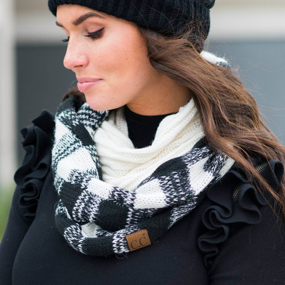 A cozy CC Buffalo Plaid Scarf featuring a classic black and red buffalo plaid pattern, perfect for stylish warmth on cold days.