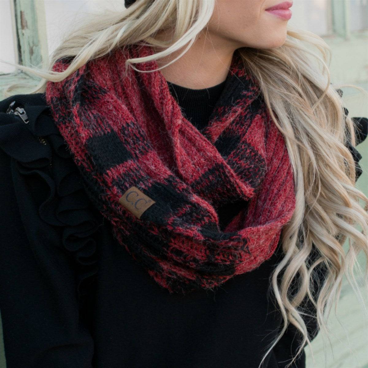 A cozy CC Buffalo Plaid Scarf featuring a classic black and red buffalo plaid pattern, perfect for stylish warmth on cold days.