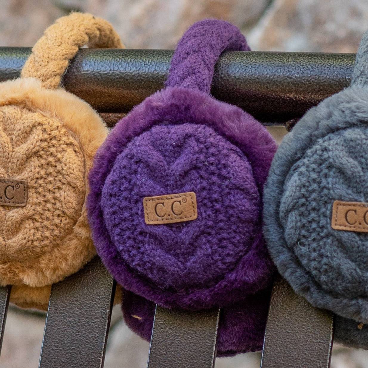 CC Cable Knit Earmuffs with cozy sherpa lining, adjustable fit, and stylish cable knit design in various colors.