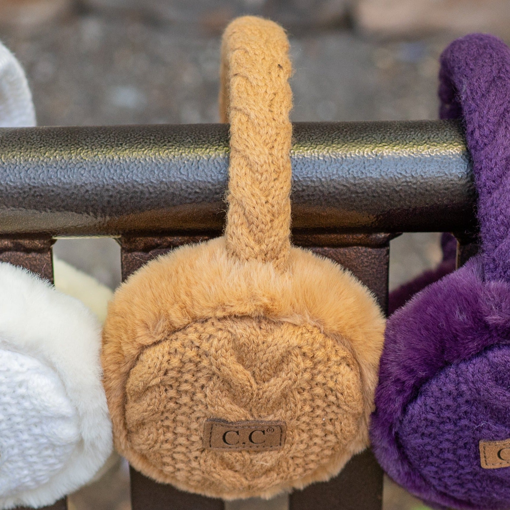 CC Cable Knit Earmuffs with cozy sherpa lining, adjustable fit, and stylish cable knit design in various colors.