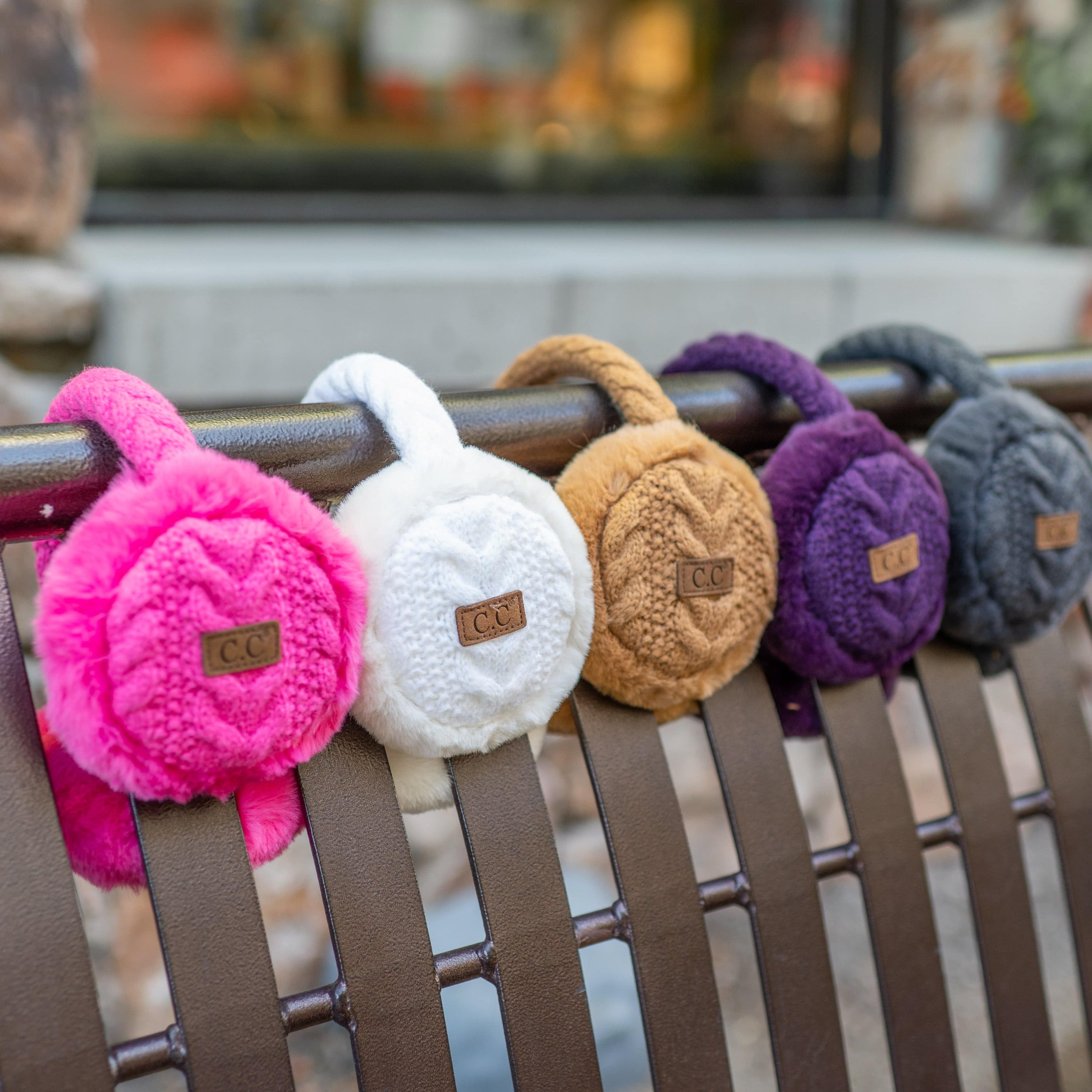 CC Cable Knit Earmuffs with cozy sherpa lining, adjustable fit, and stylish cable knit design in various colors.