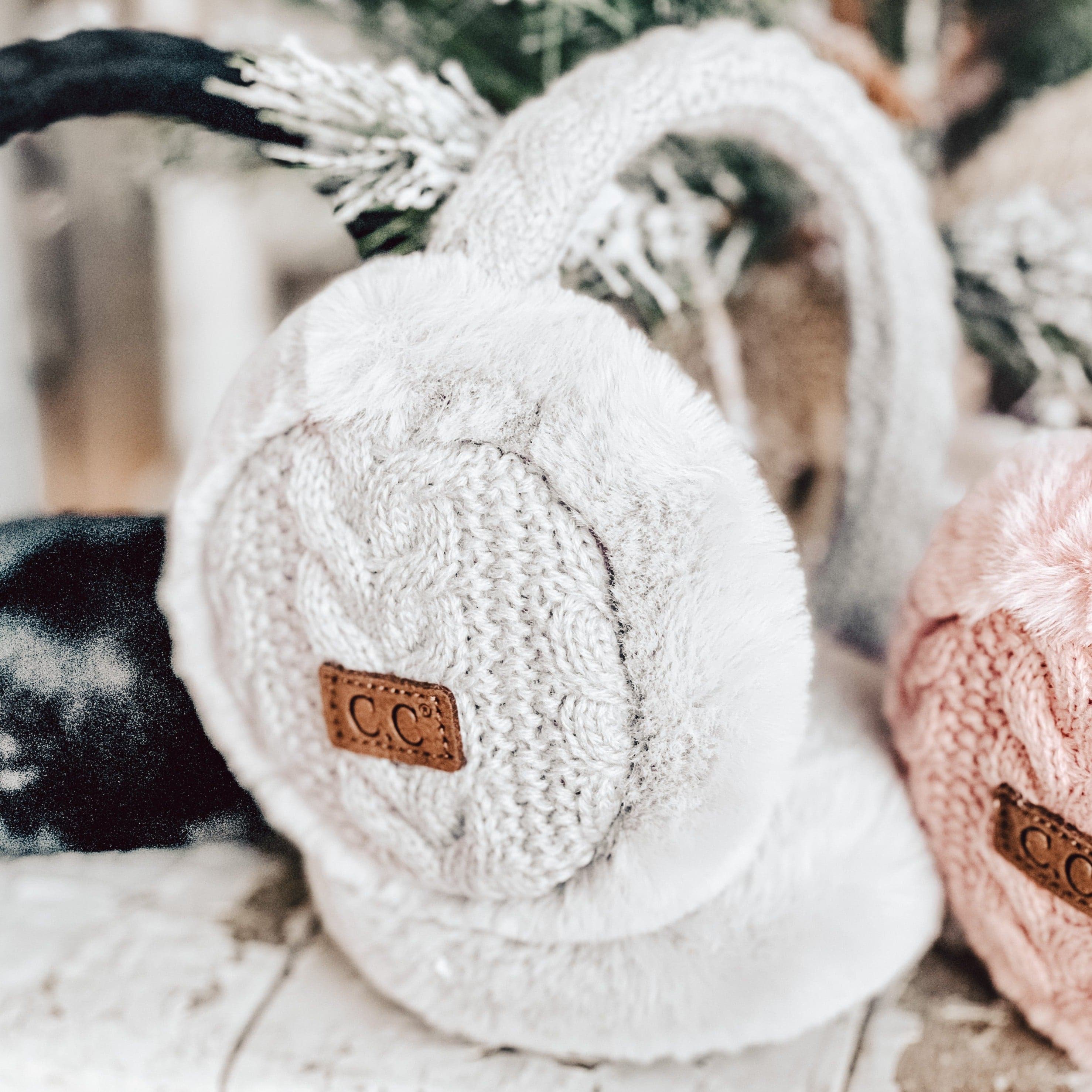 CC Cable Knit Earmuffs with cozy sherpa lining, adjustable fit, and stylish cable knit design in various colors.