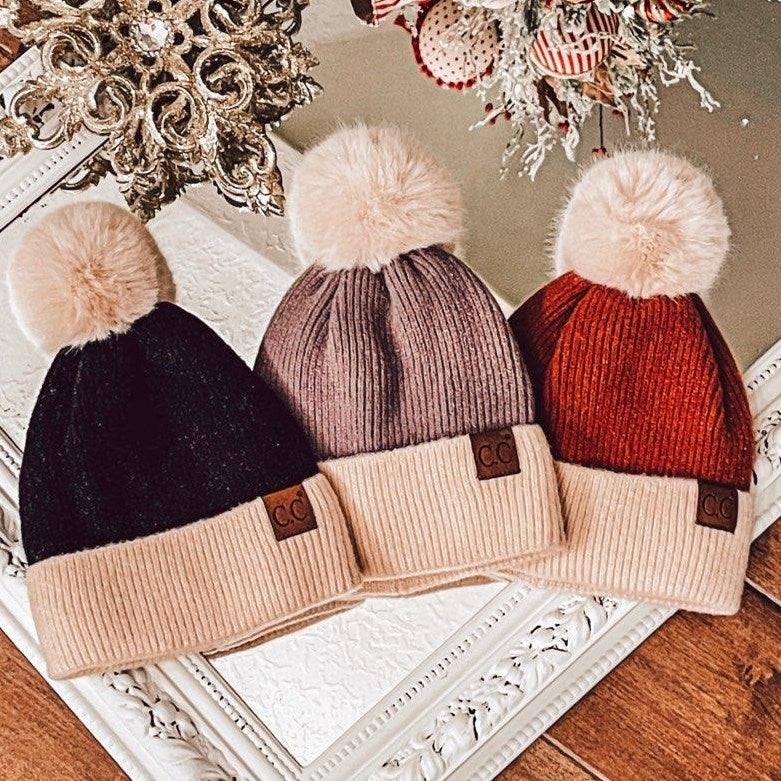 CC Festive Beanie featuring a faux fur pom and metallic detail, perfect for winter style.